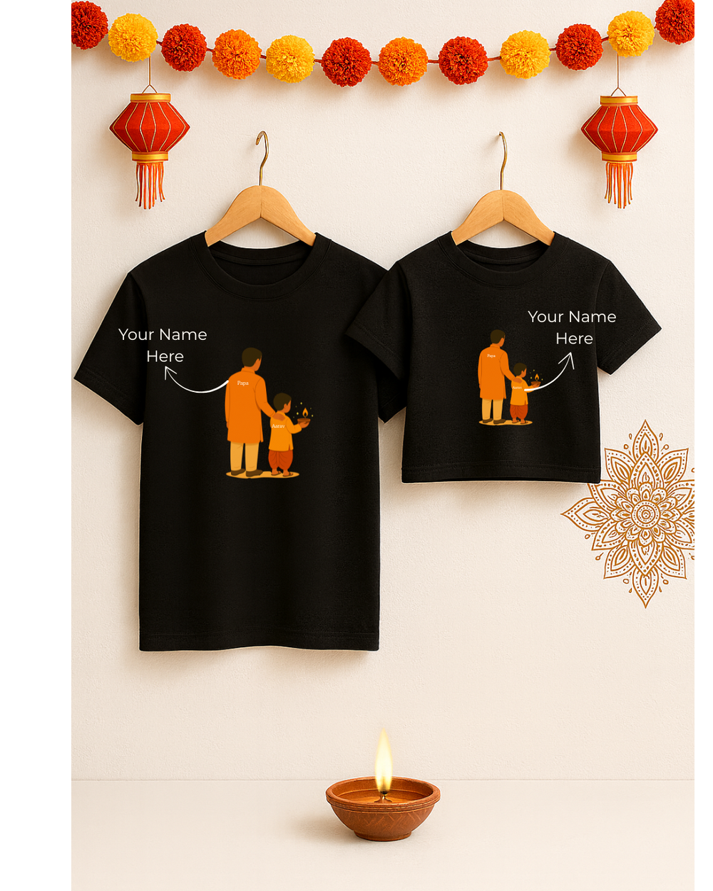 Two black t-shirts with a printed design and 'Your Name Here' text, hanging on wooden hangers against a light background with decorative elements.
